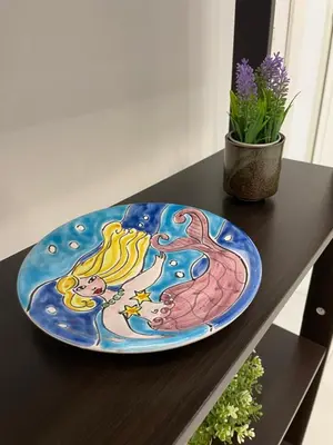 a plate with two women on a table at Casa Carmela Mondello in Palermo