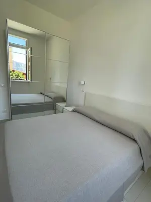 a bedroom with a large bed and a mirror at Casa Carmela Mondello in Palermo