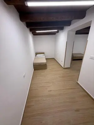 a room with two beds and a wooden floor at La Dimora del CAPO in Palermo