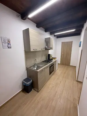 a kitchen with a sink and a stove in a room at La Dimora del CAPO in Palermo