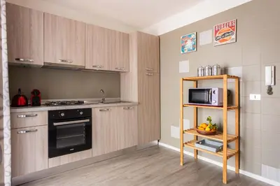 a small kitchen with a stove and a microwave at Apartment with 2 Terraces near Teatro Massimo in Palermo