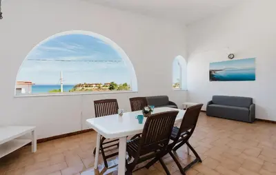 a living room with a table and chairs and a window at Stunning Apartment In Balestrate in Balestrate