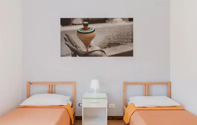 two beds in a room with a picture on the wall at Stunning Apartment In Balestrate in Balestrate