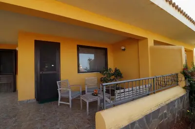 a balcony of a house with a table and chairs at Villa Belorizzonte - Relax & Sea in Mandra Capreria