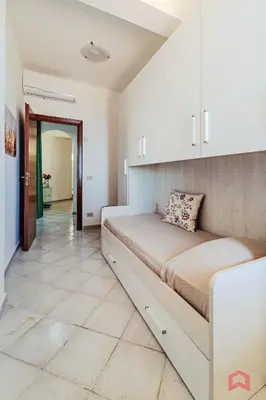 a bedroom with a large bed in a room at Delizioso Appartamento in villa & Piscina Privata in Trabia