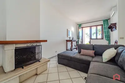 a living room with a couch and a fireplace at Delizioso Appartamento in villa & Piscina Privata in Trabia
