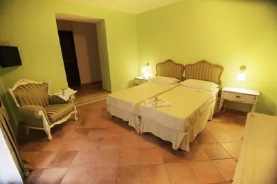 a bedroom with a large bed and two chairs at Antica Palermo R&B in Palermo