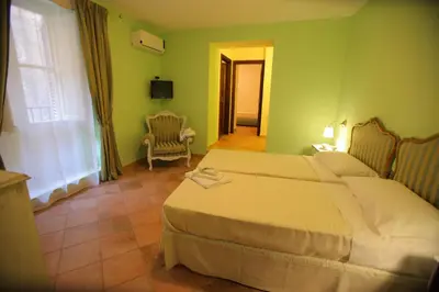 a bedroom with a bed in a green room at Antica Palermo R&B in Palermo