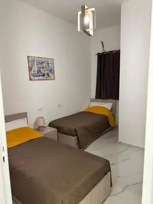 a room with two beds in a room at Vitale House in Borgetto