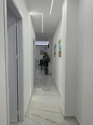 a hallway with white walls and white floors at Vitale House in Borgetto