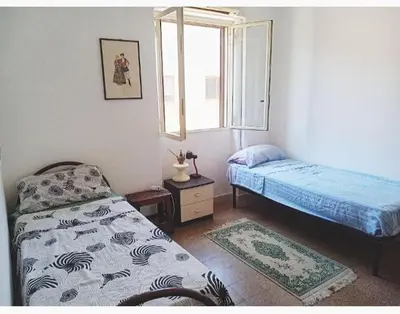 a bedroom with a bed and a window at City-Inn II with 2 comfortable single beds in Palermo