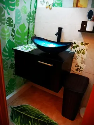 a bathroom with a blue sink on a black vanity at A meravigghia Casa vacanze in Bagheria