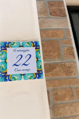 a sign on the side of a table at A meravigghia casa vacanze in Bagheria