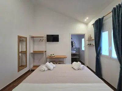 a bedroom with a large white bed with two pillows at Angelina Rooms in Palermo