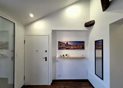 a hallway with white walls and a white door at Angelina Rooms in Palermo
