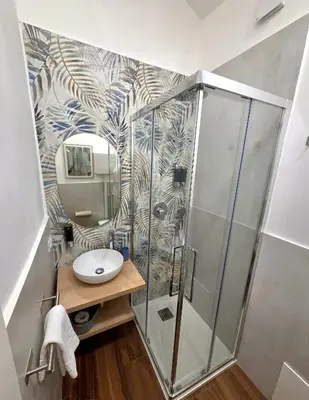 a bathroom with a shower and a sink at Angelina Rooms in Palermo