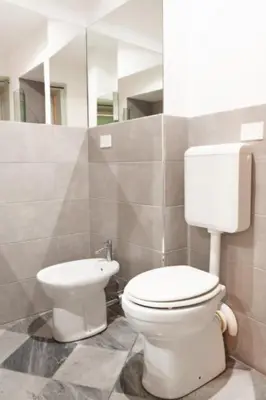 a bathroom with a toilet and a sink at MojoCoHouse in Palermo