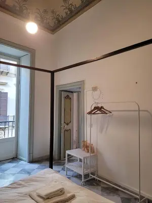 a room with a bed and a table in it at MojoCoHouse in Palermo