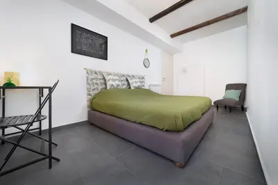 a bedroom with a bed and a table and a chair at MojoCoHouse in Palermo