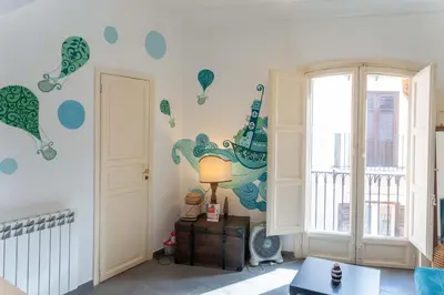a room with blue and green decals on the wall at MojoCoHouse in Palermo