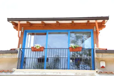 a blue window with potted plants on a balcony at B&B Menta & Peperoncino in Partinico