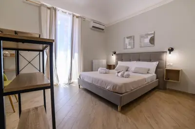 a bedroom with a bed with two towels on it at Oros rooms in Palermo