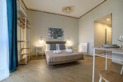 a bedroom with a bed with two pillows on it at Oros rooms in Palermo