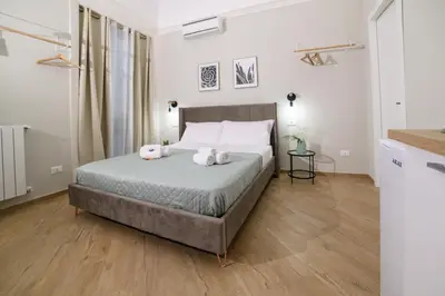 a bedroom with a bed with two stuffed animals on it at Oros rooms in Palermo