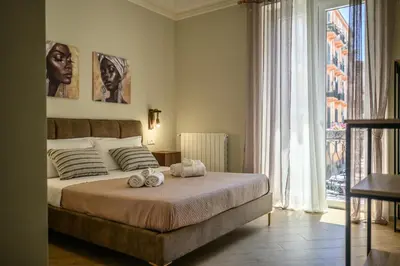 a bedroom with a bed with two stuffed animals on it at Oros rooms in Palermo