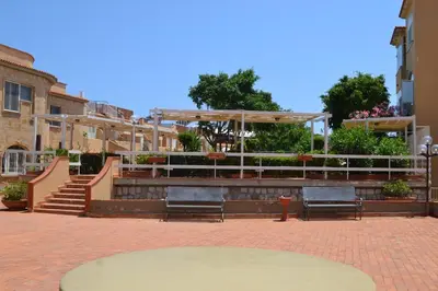 a group of benches in a courtyard with stairs at La Dimora di Alice in Palermo