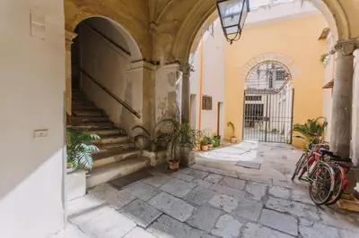 an entrance to a building with two bikes parked in a hallway at Real Umberto Apartments by Wonderful Italy in Palermo