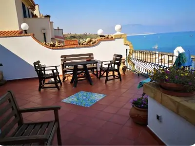 a patio with a table and chairs on a balcony at Villa Adele in Trappeto