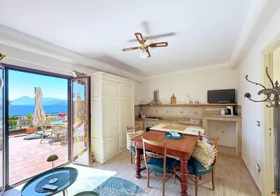 a dining room with a table and a view of the ocean at Solemar Sicilia - Palazzo Tiglio in Porticello