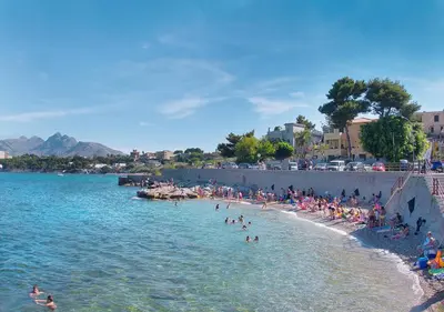 a group of people on a beach in the water at Solemar Sicilia - Palazzo Tiglio in Porticello