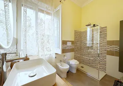 a bathroom with a tub and a toilet and a sink at Solemar Sicilia - Palazzo Tiglio in Porticello