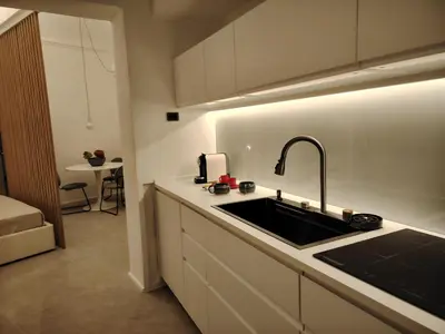 a kitchen with a sink and a counter top at Cappuccetto Rosso Sweet Modern Suite Palermo in Palermo