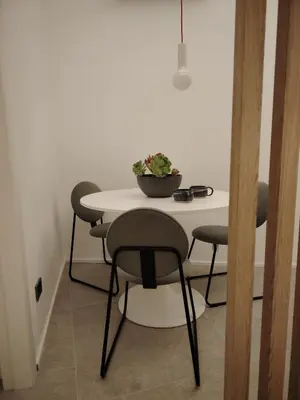 a table and chairs with a potted plant on it at Cappuccetto Rosso Sweet Modern Suite Palermo in Palermo