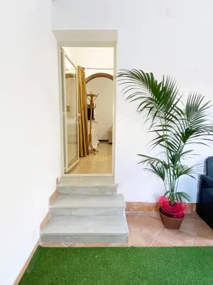 a white house with a staircase and a plant at Il Vialetto in Mondello