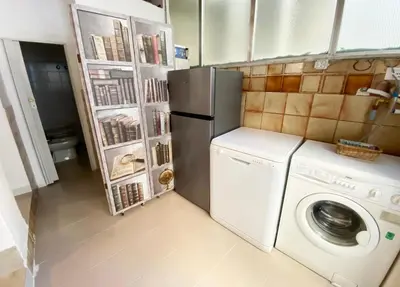 a kitchen with a refrigerator and a washing machine at Il Vialetto in Mondello