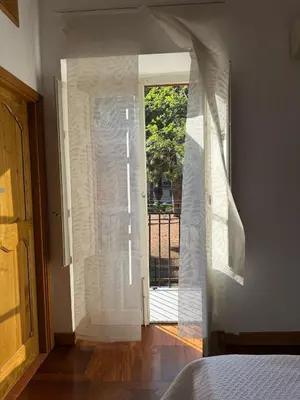 a bedroom with a sliding glass door to a patio at Dimora 51 in Palermo