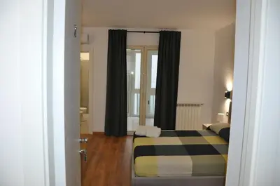 a bedroom with a bed with a black and yellow blanket at Casa Giovannella in Palermo
