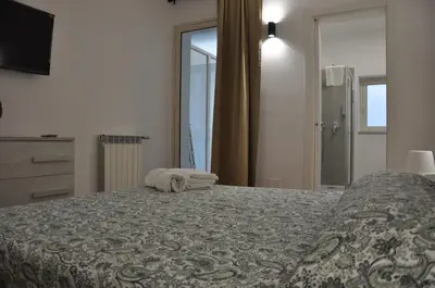 a bedroom with a large bed and a window at Casa Giovannella in Palermo