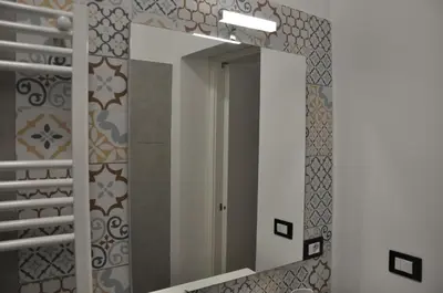a bathroom with a mirror and a staircase at Casa Giovannella in Palermo