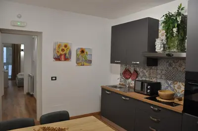 a kitchen with black cabinets and a counter top at Casa Giovannella in Palermo