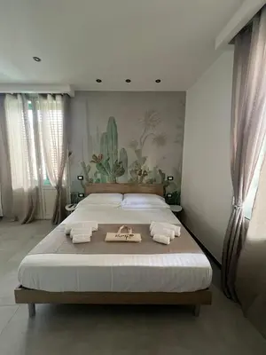 a bedroom with a large bed with towels on it at kumpa' sicilian apartments in Palermo