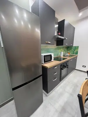 a kitchen with a stainless steel refrigerator at kumpa' sicilian apartments in Palermo