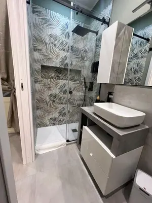 a bathroom with a sink and a shower at kumpa' sicilian apartments in Palermo