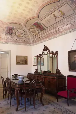 a dining room with a table and a mirror at Casa Tramontana Ospitalità Diffusa in Castronuovo di Sicilia