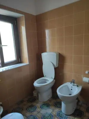 a bathroom with a toilet and a sink at Casa Tramontana Ospitalità Diffusa in Castronuovo di Sicilia