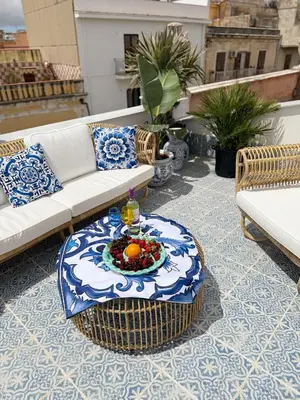 a patio with a table and couches on a roof at Opera Dolce in Carini